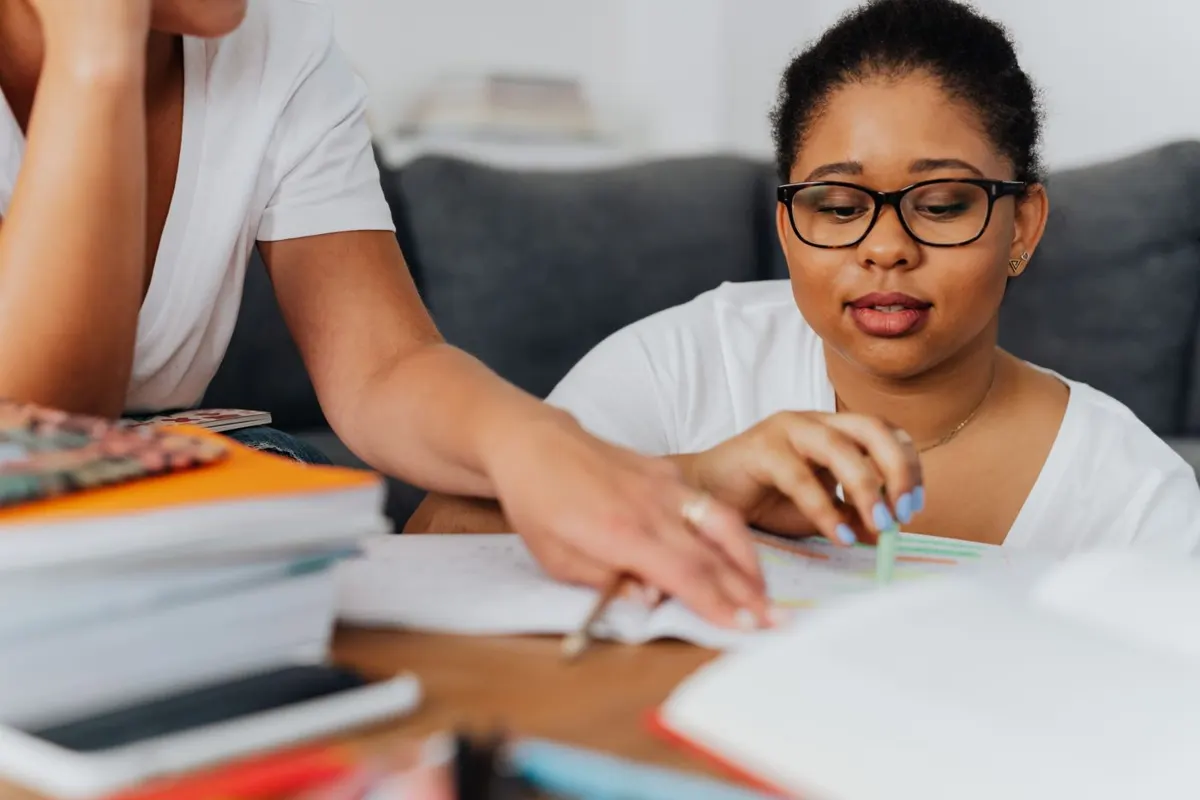 A tutor explaining notes to a student during a one-on-one session